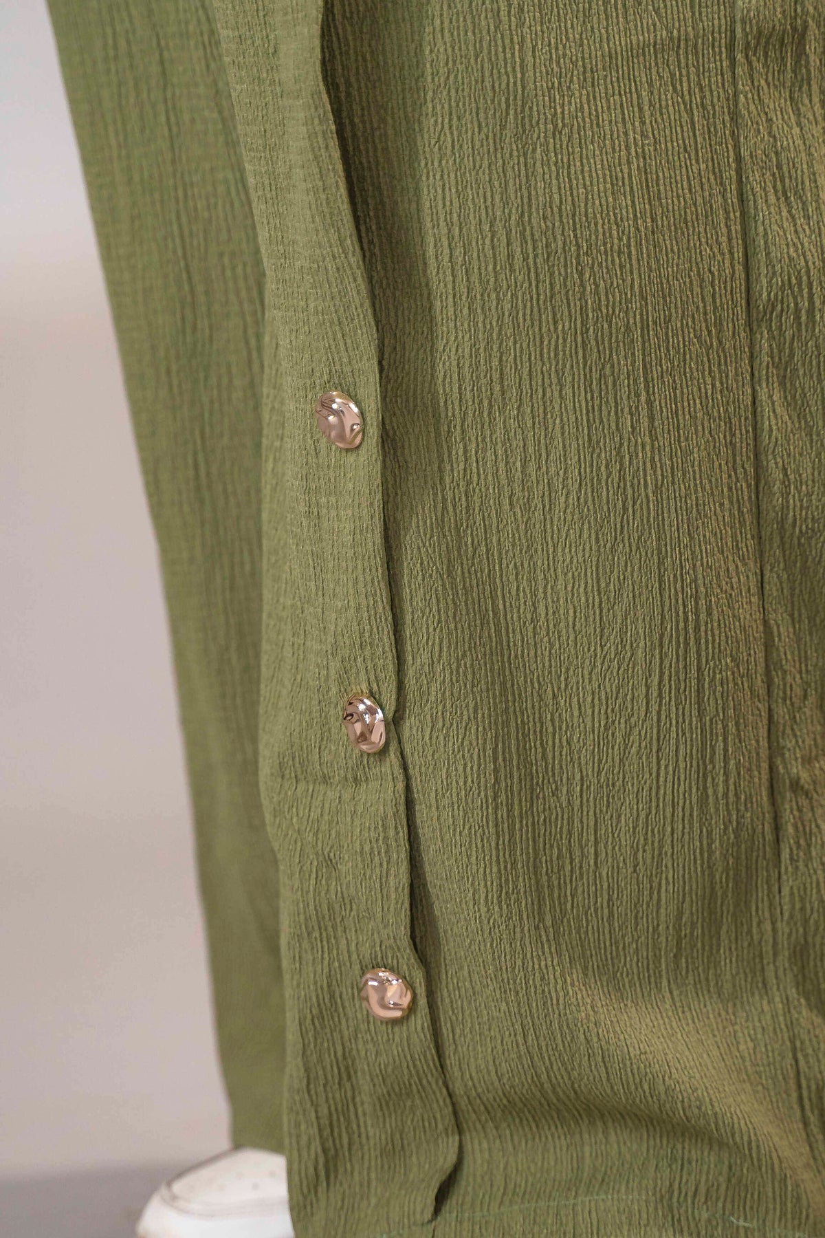 Olive green suit with a side-tie design